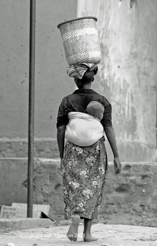Women carrying child and washing, Kenya